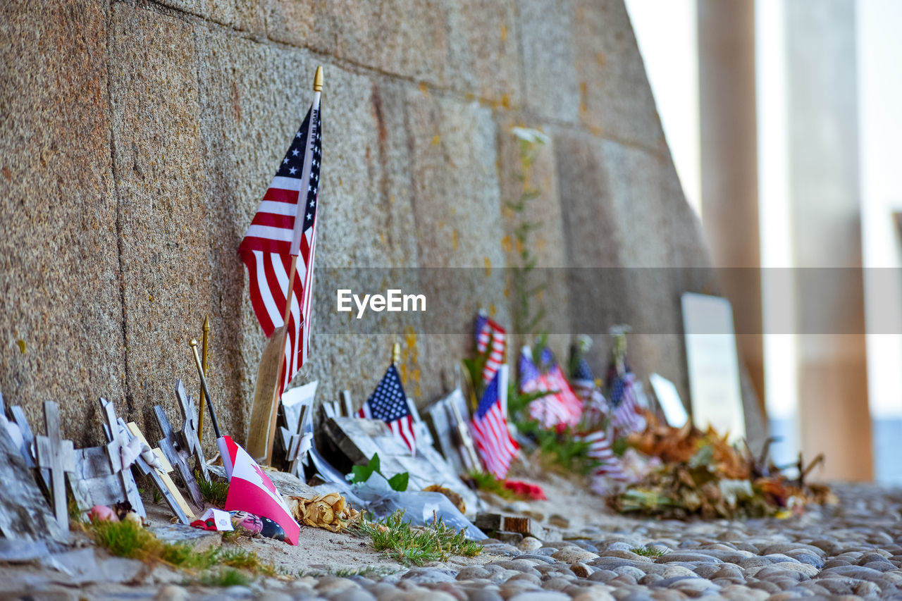 Detail of u.s. flag in the monument to the brave on the historic beach called omaha beach 