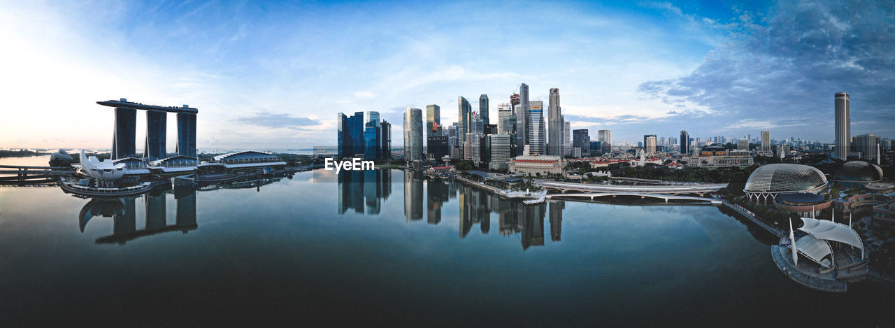 Panoramic view of singapore city buildings against sky