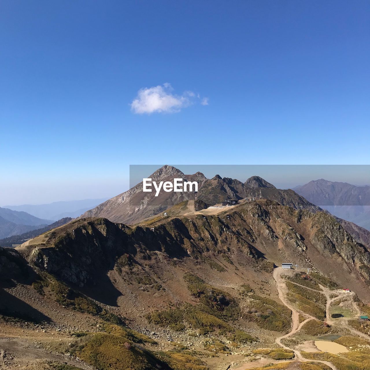 View of mountain range against blue sky