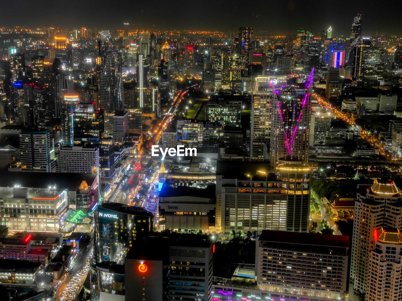 High angle view of illuminated city buildings at night