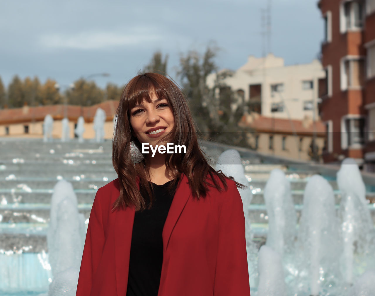 Portrait of smiling woman standing outdoors