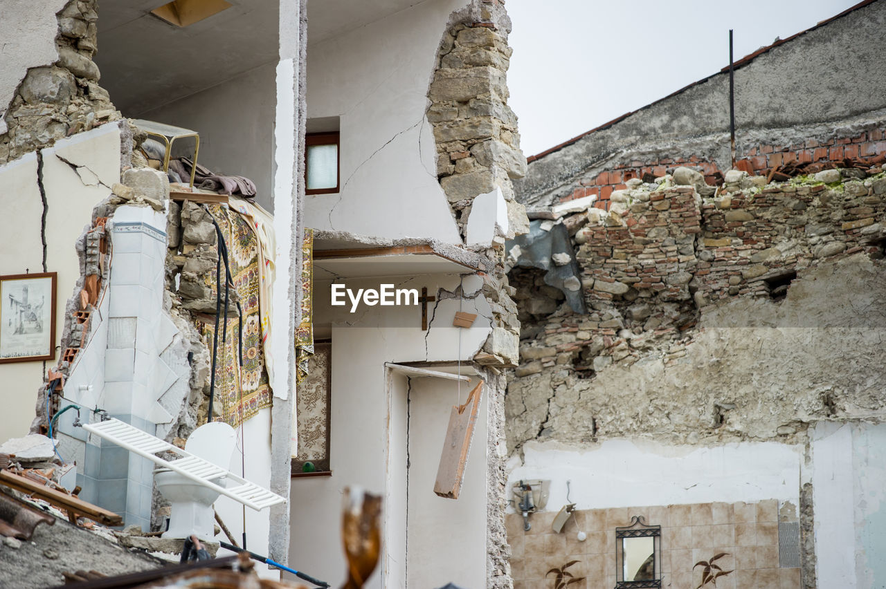 LOW ANGLE VIEW OF ABANDONED BUILDINGS