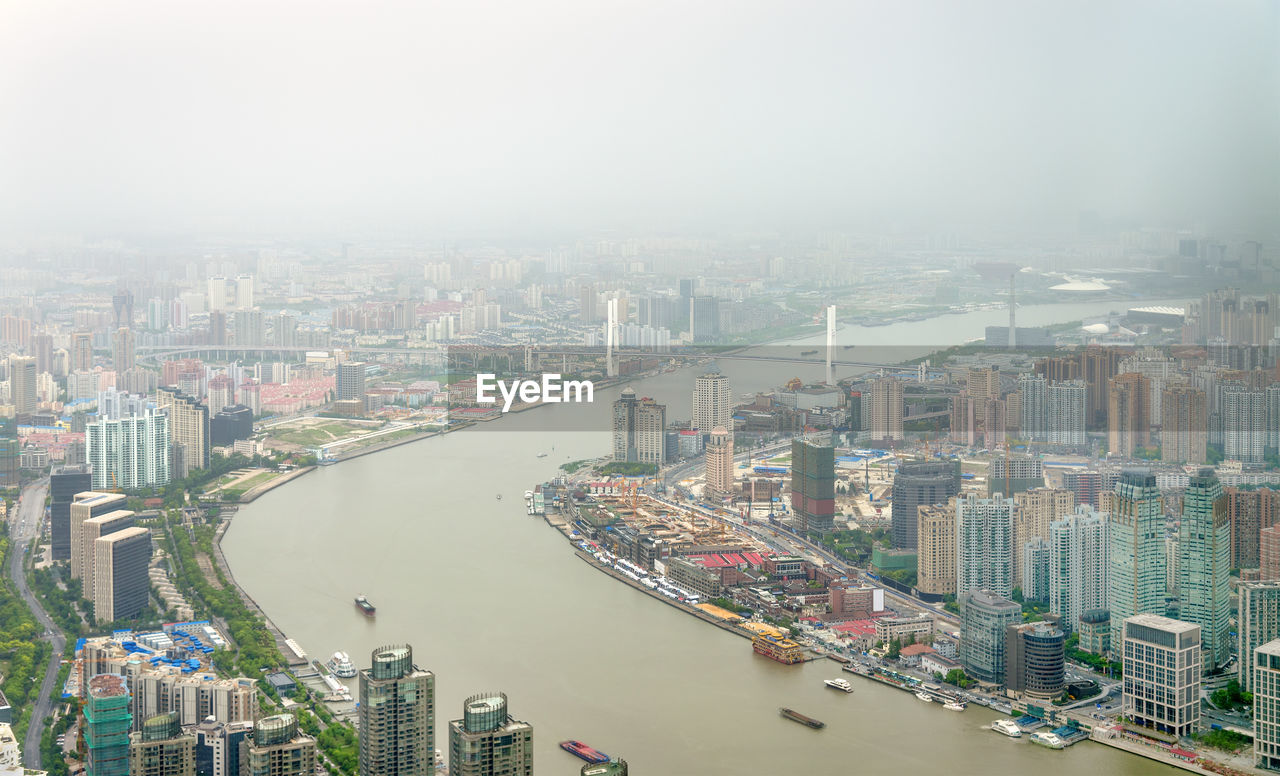 HIGH ANGLE VIEW OF BUILDINGS AGAINST SKY