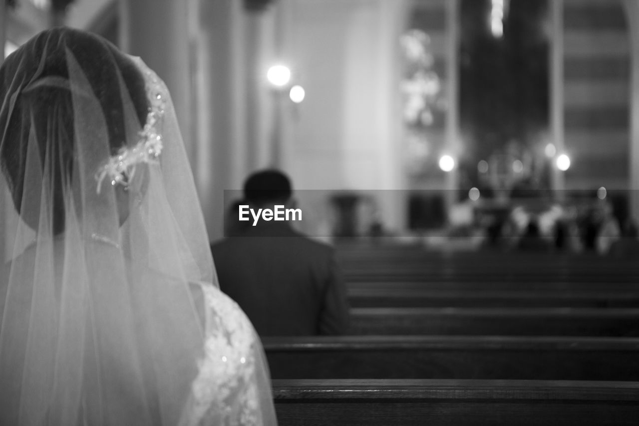 Close-up of bride sitting in church