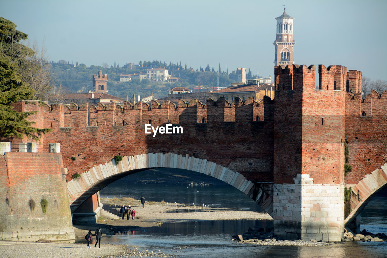 Arch bridge over river in city