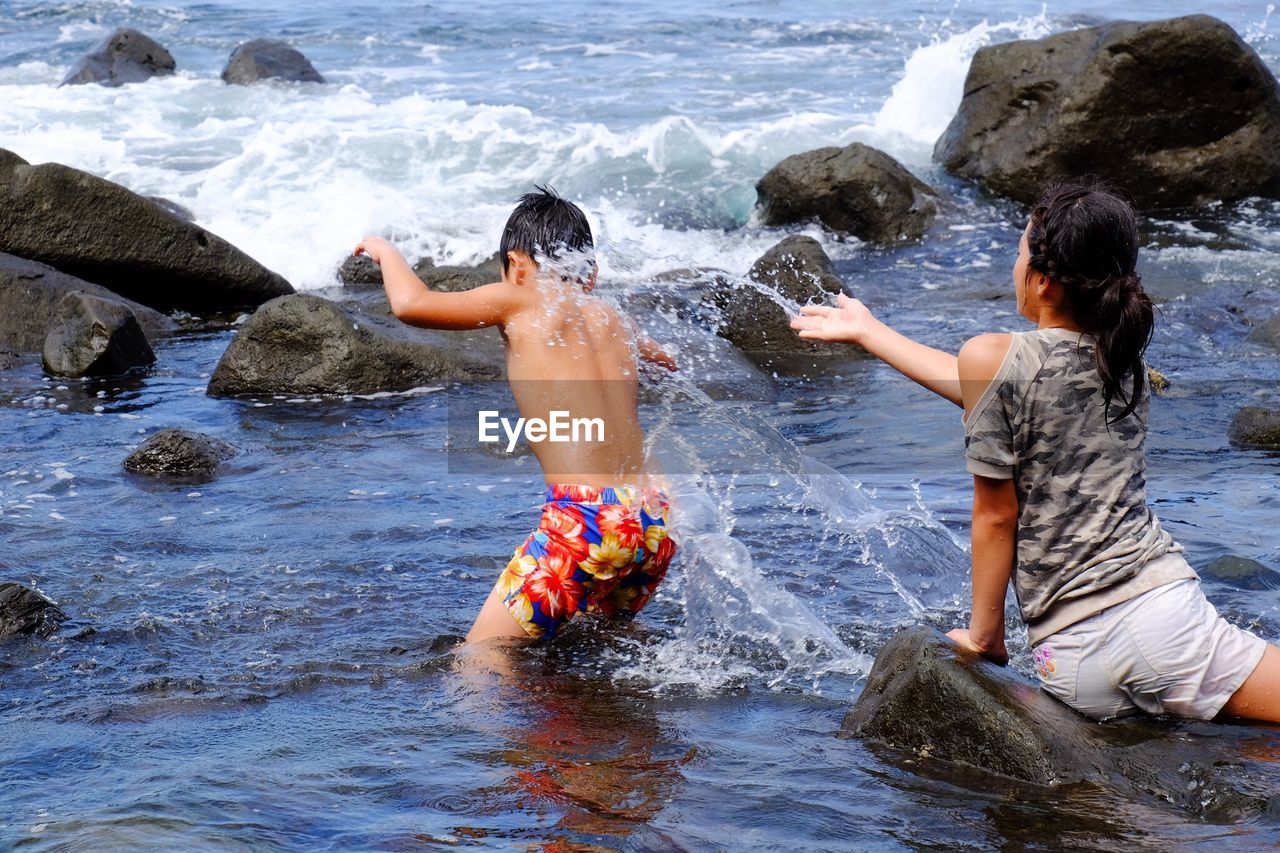 WAVES SPLASHING ON ROCKS AT SHORE