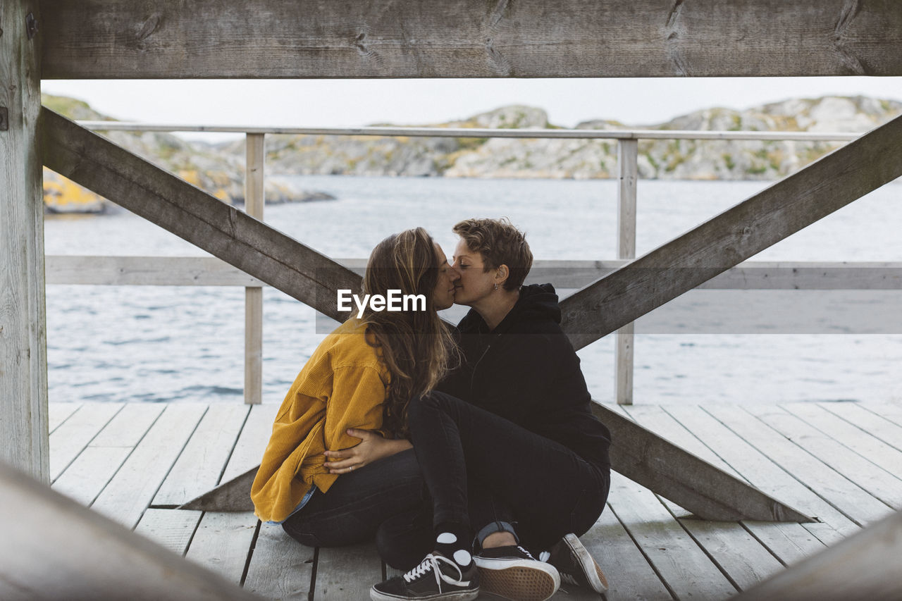 Women kissing on jetty