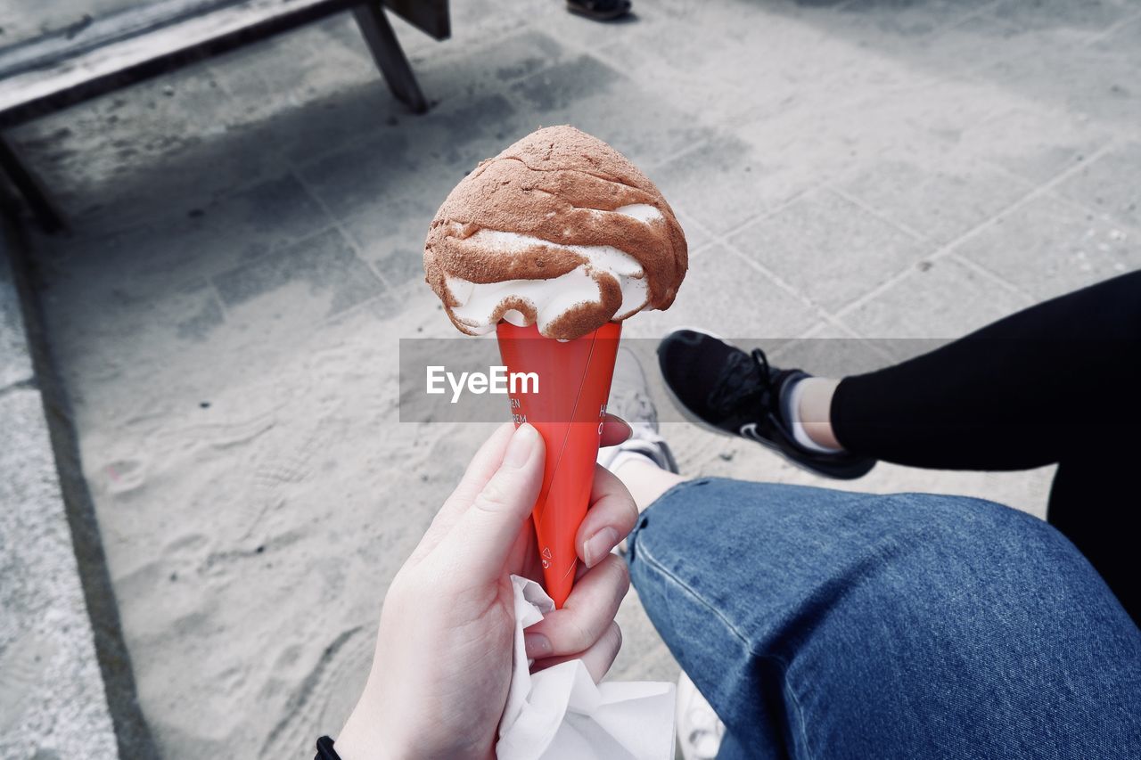 Low section of person holding ice cream cone
