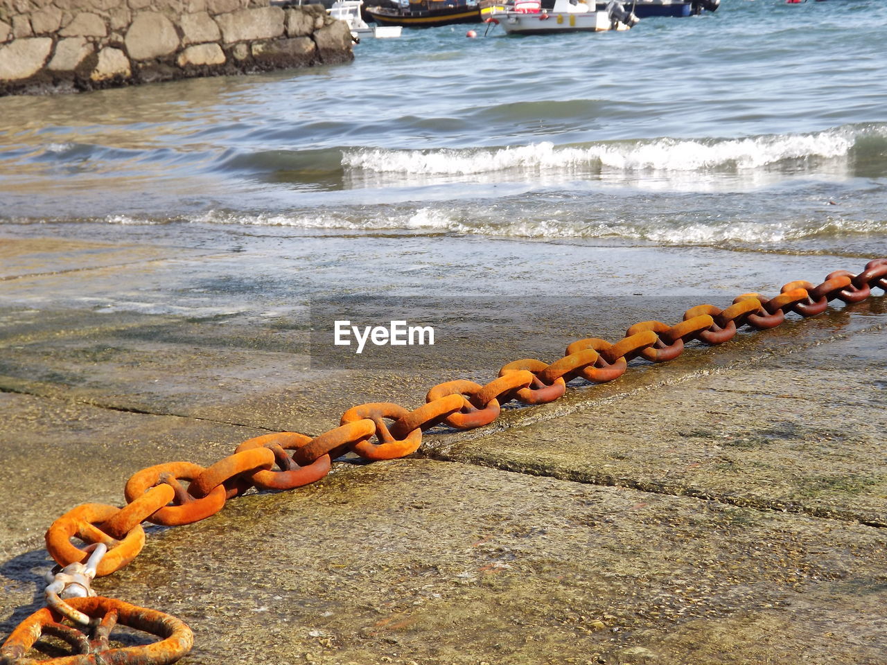 ROW OF METAL CHAIN ON SHORE