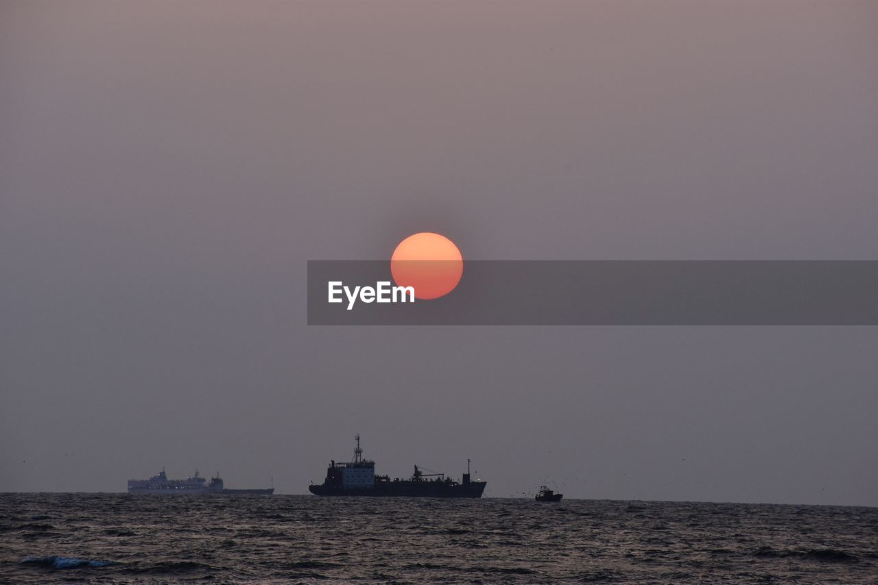 Scenic view of sea against clear sky at night