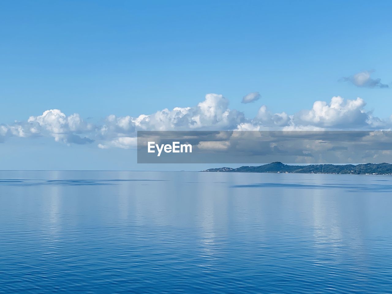 Scenic view of sea against blue sky