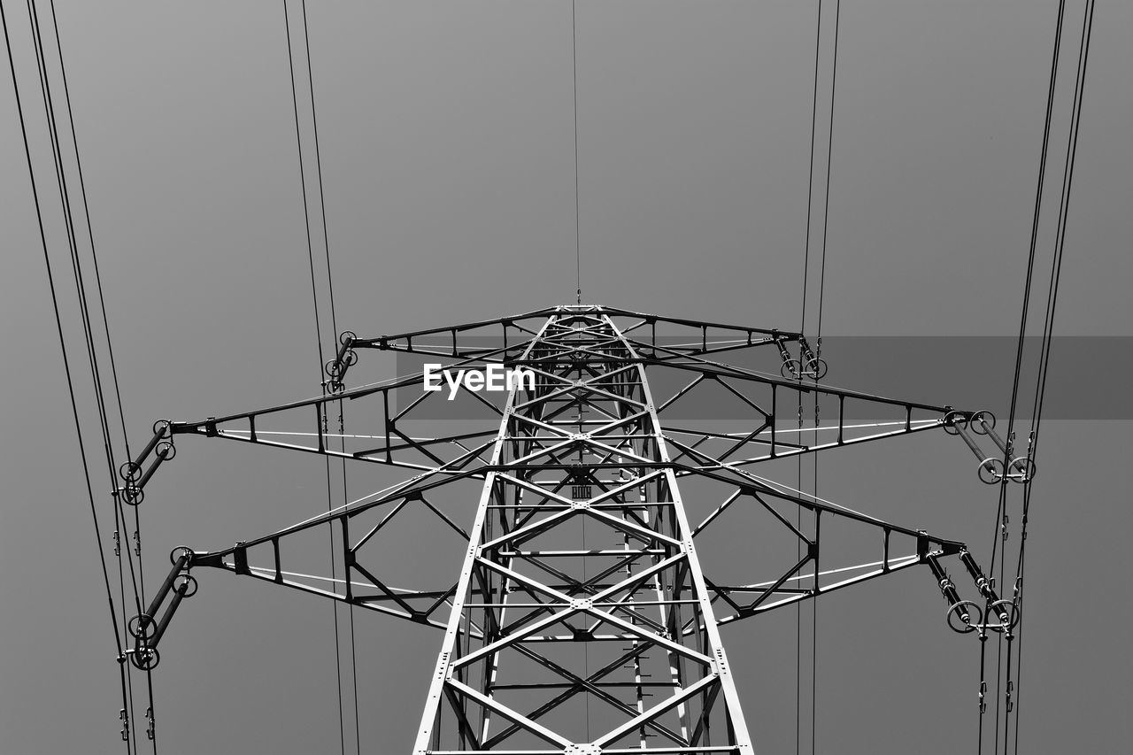 Low angle view of electricity pylon against sky