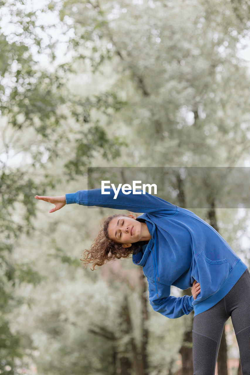 A european woman does sports in a park or a public place. warm-up and jogging in the fresh air