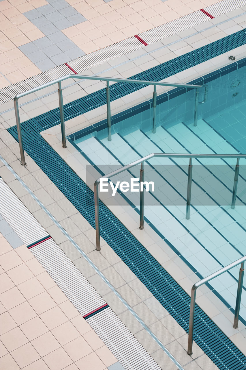 High angle view of steps in swimming pool against building