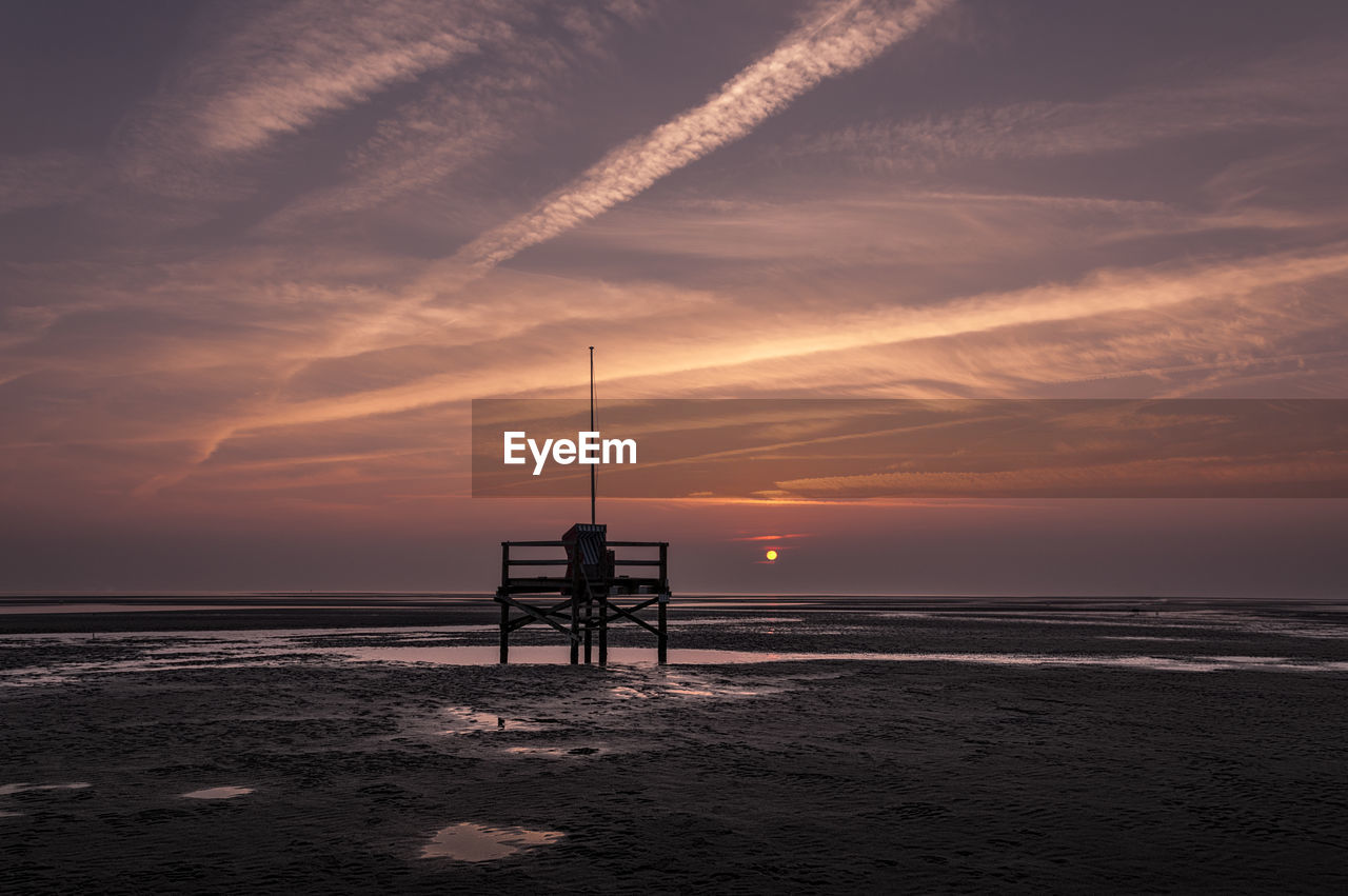 Scenic view of beach against sky during sunset