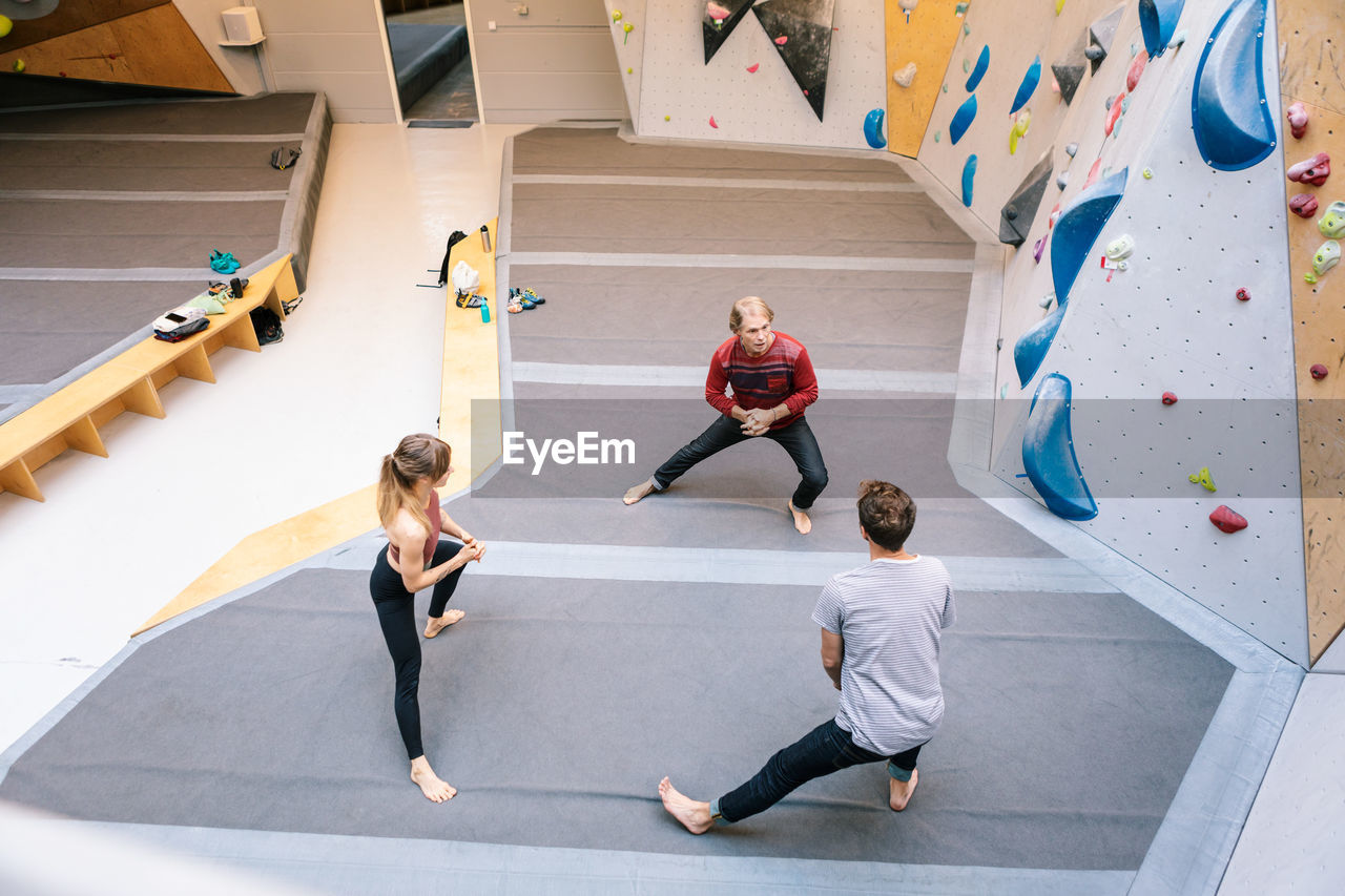 High angle view of coach training students at gym