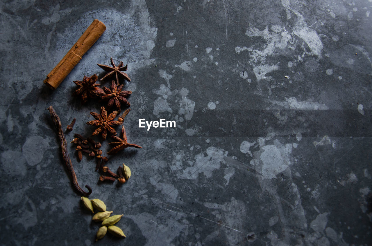 High angle view of dry spices on a textured table