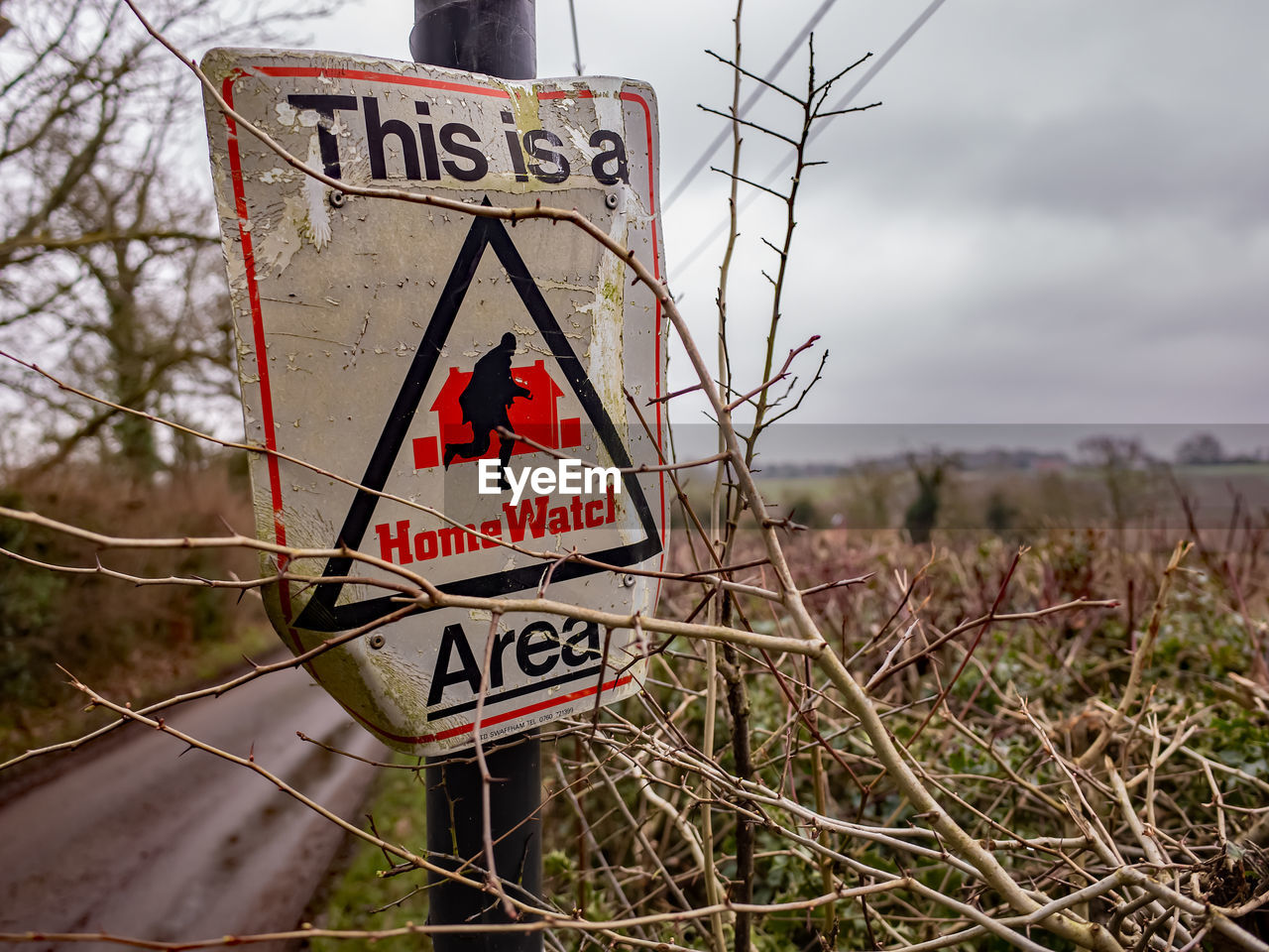 Information sign on road against sky