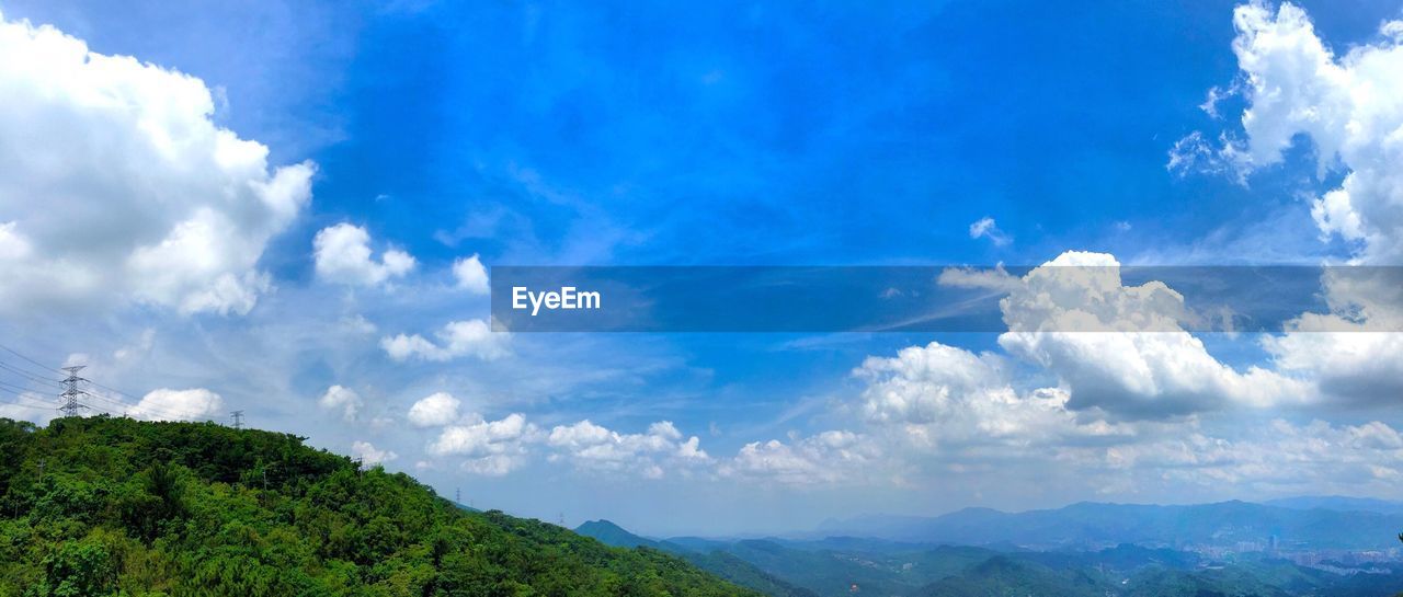 Scenic view of mountains against cloudy sky