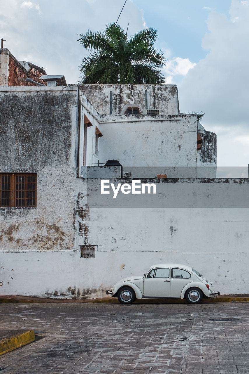 CAR ON STREET AGAINST BUILDINGS