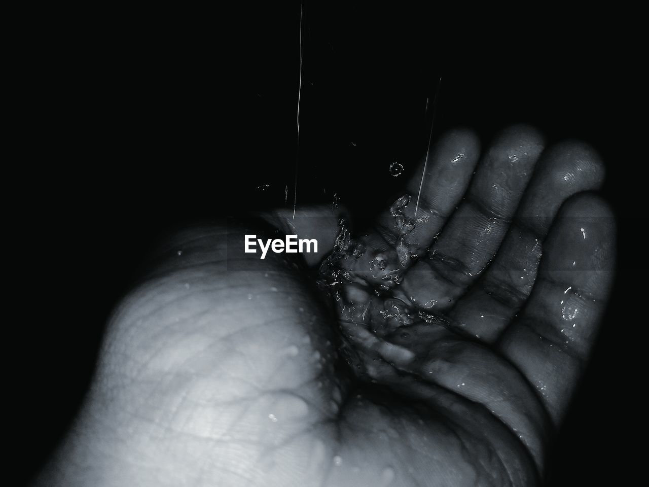 CLOSE-UP OF HUMAN HAND WITH WATER