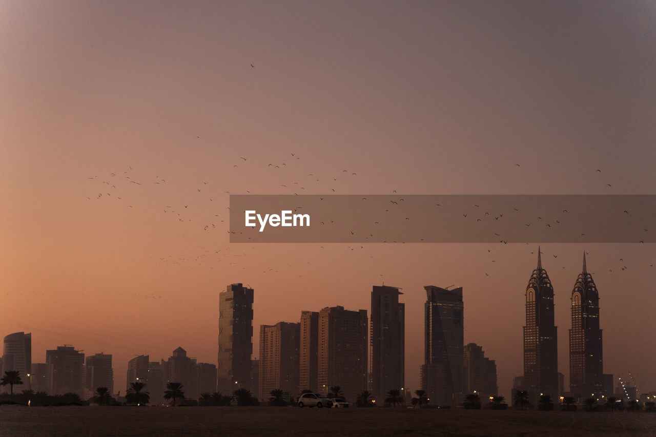 Cityscape against sky during sunset