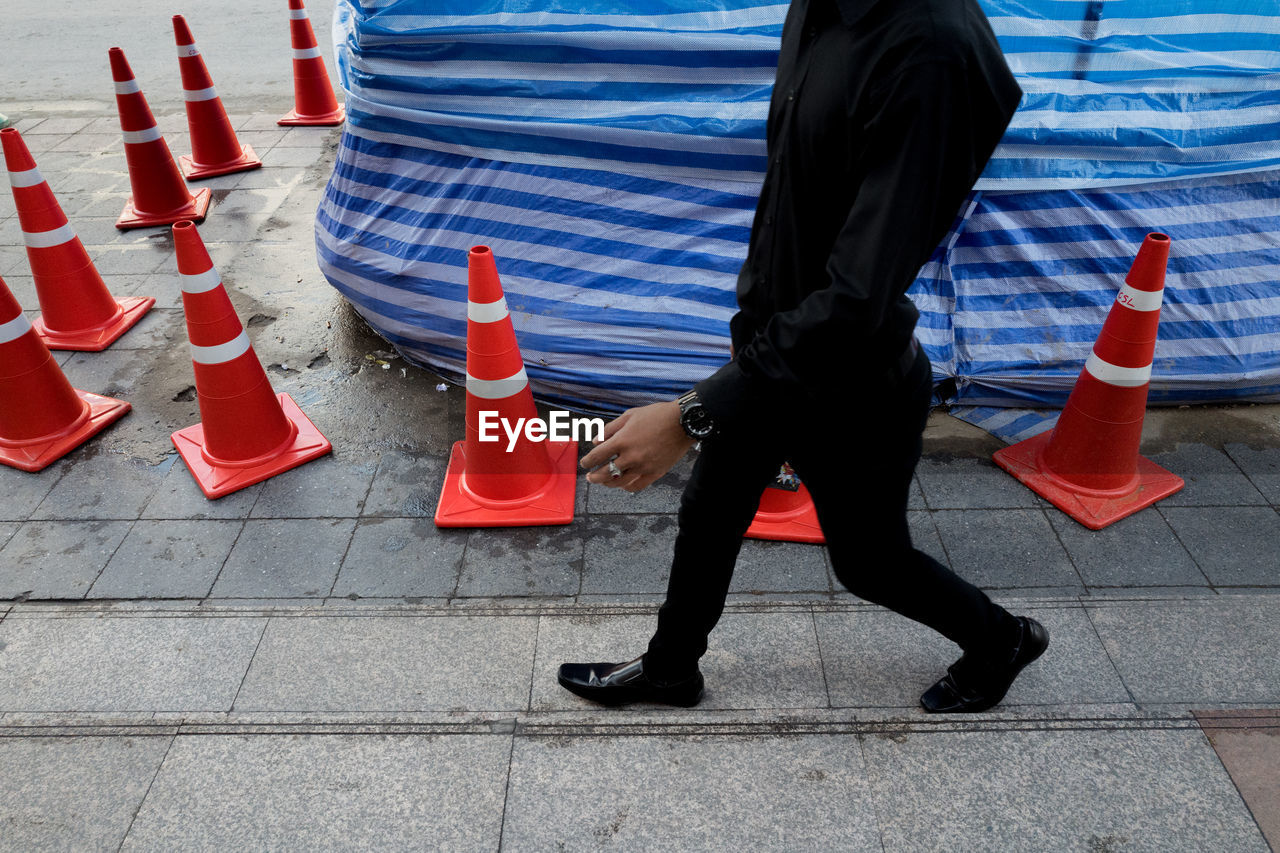 Low section of man walking on footpath