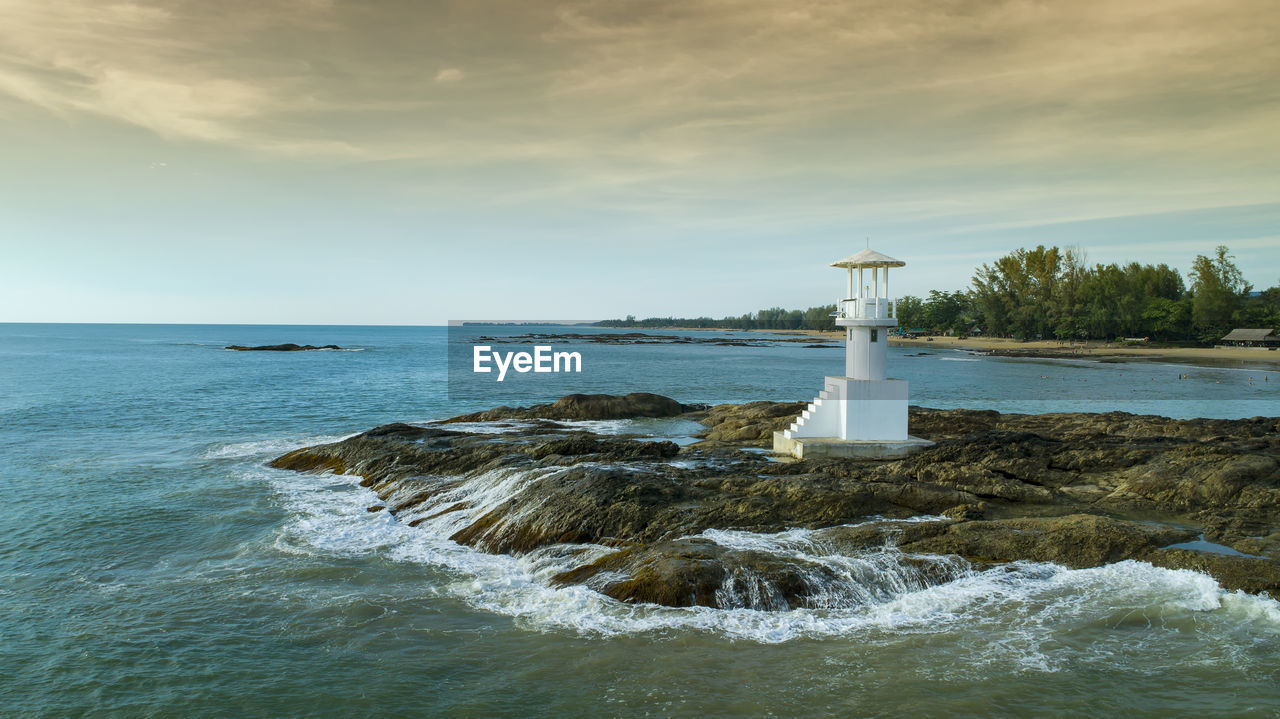 LIGHTHOUSE AMIDST SEA AGAINST SKY