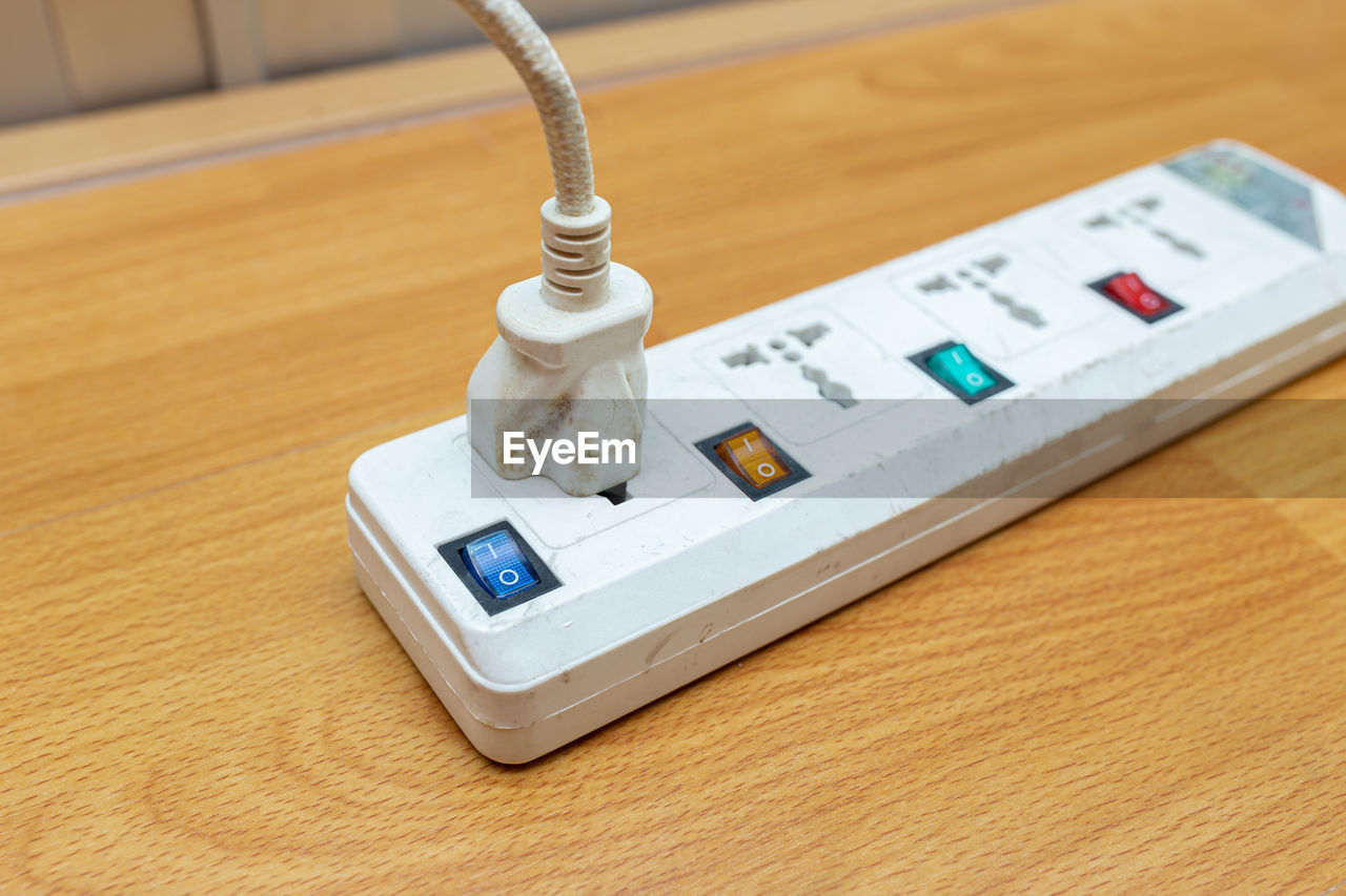 Close-up of electrical outlet on table