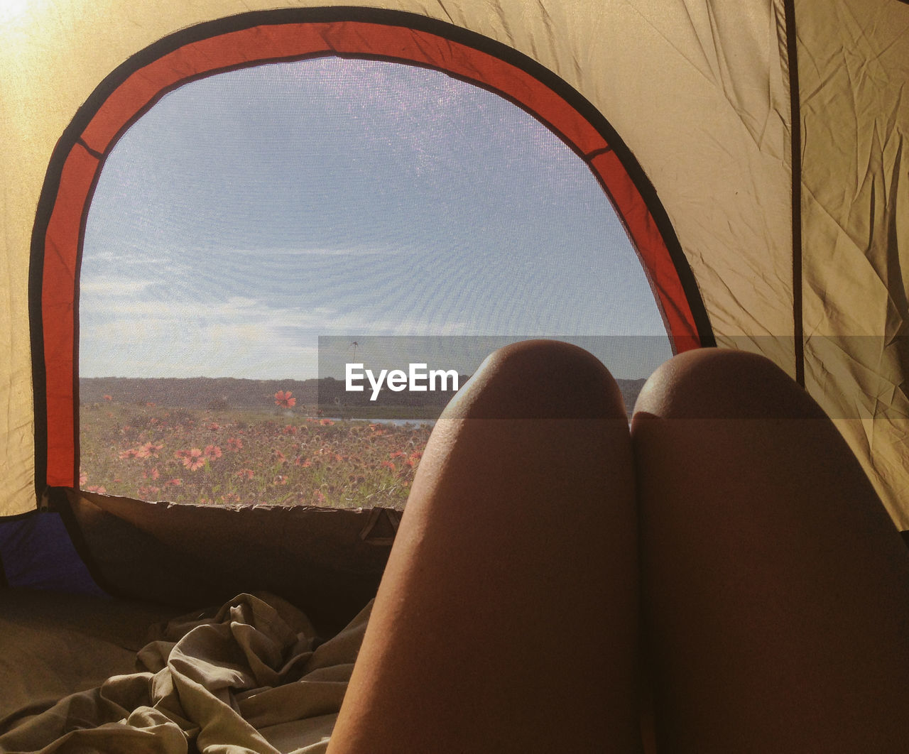 Midsection of woman in tent against sky