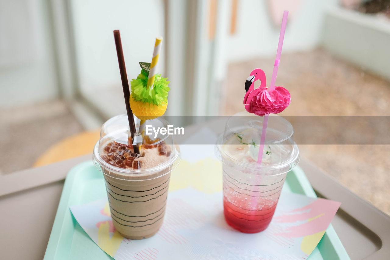 Close up of milk tea and strawberry soda on the table, drinks at cafe.