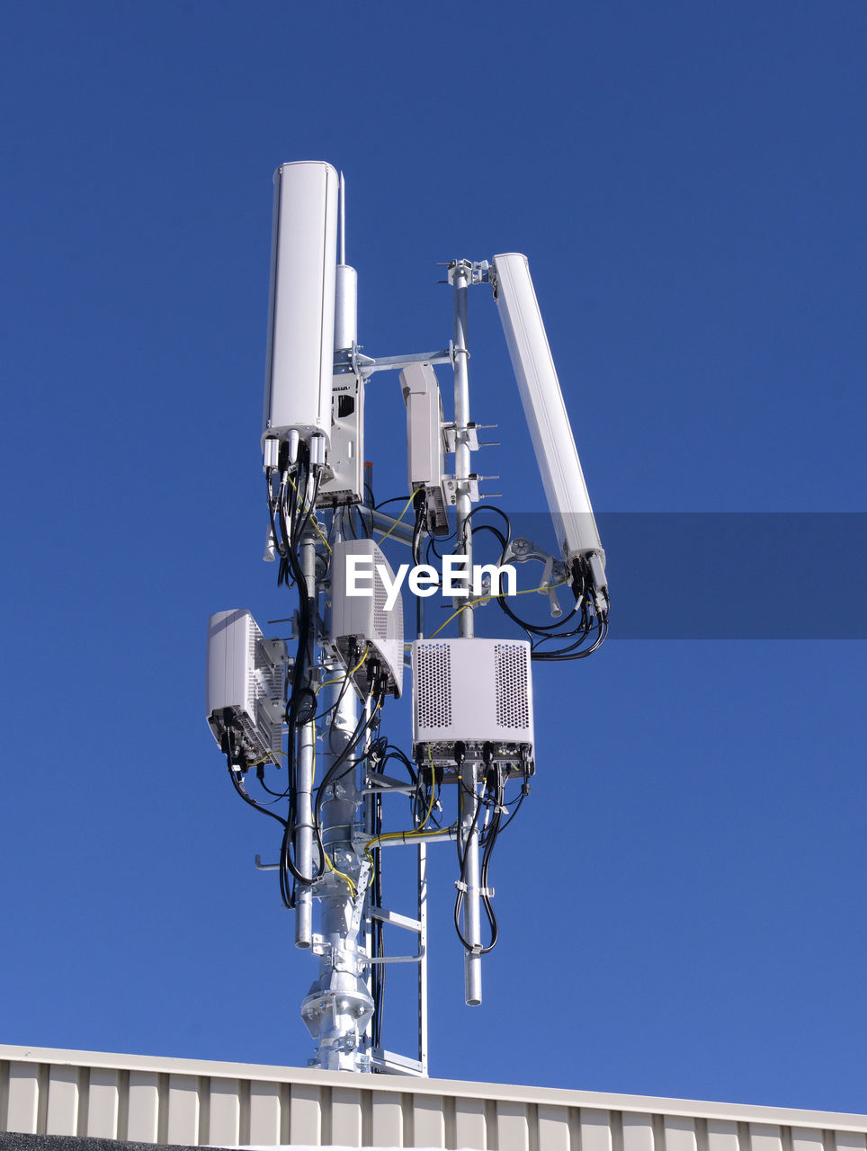 Low angle view of antenna against clear blue sky