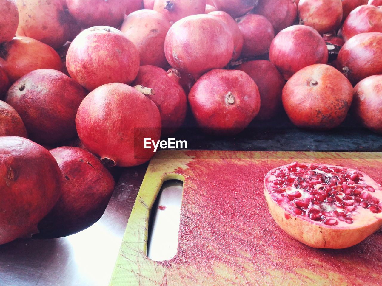 Close-up of halved pomegranate on cutting board