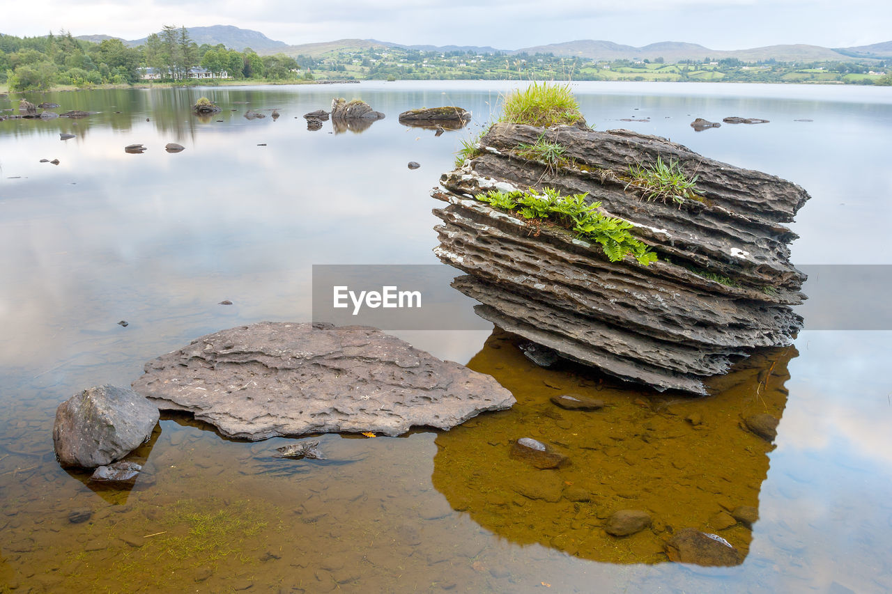 Scenic view of rock by lake