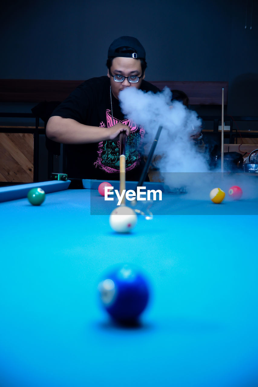 portrait of man playing pool