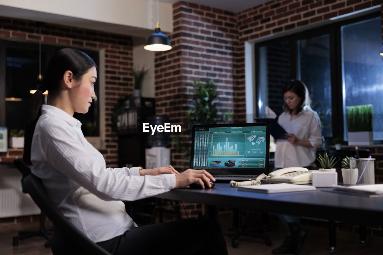 Businesswoman using laptop at office