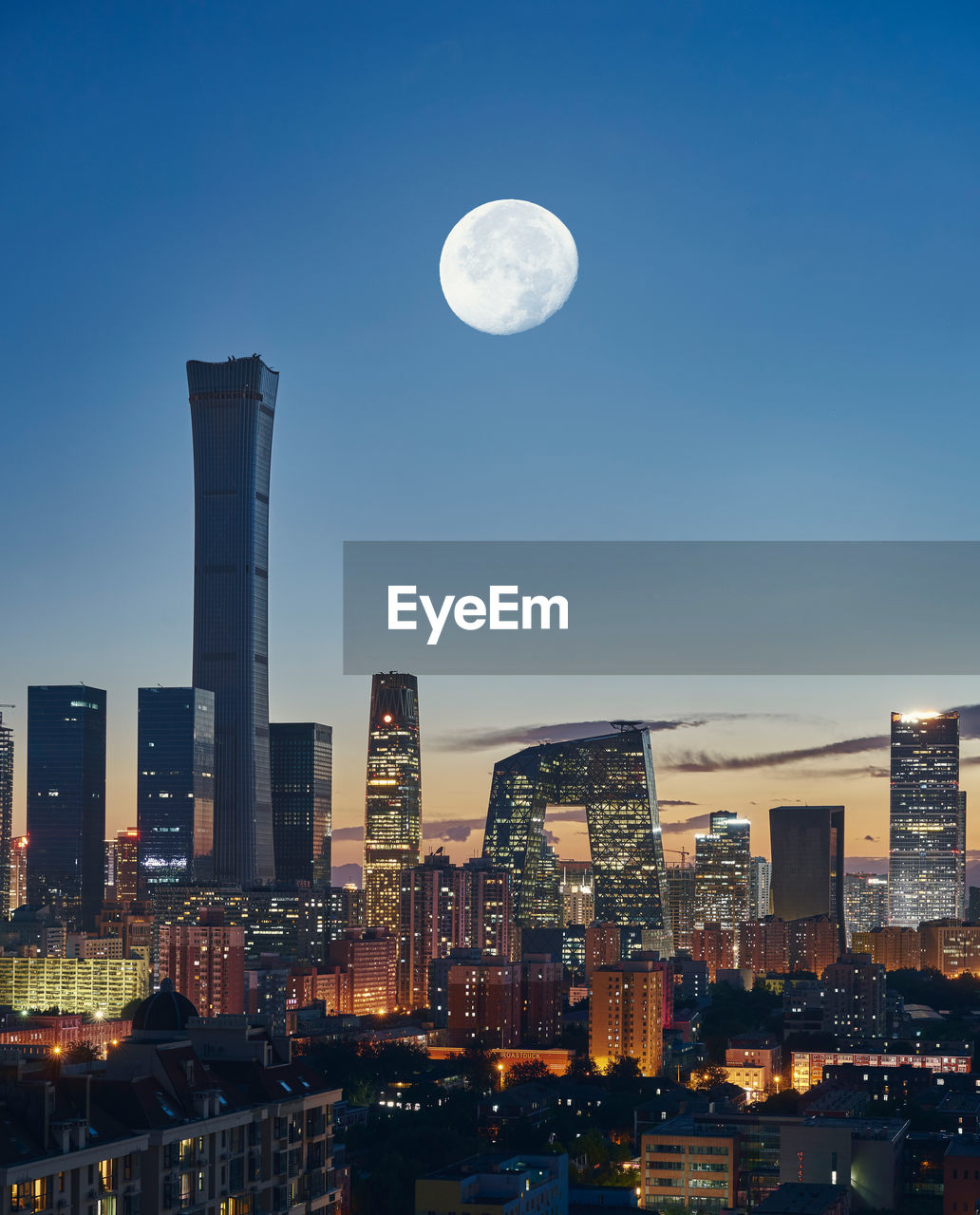 Aerial view of illuminated buildings against sky at night