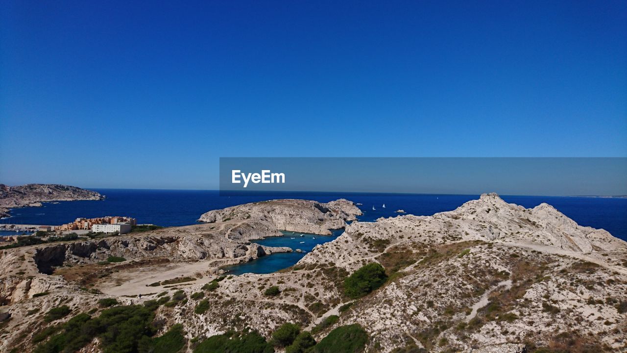 Panoramic view of sea against clear blue sky