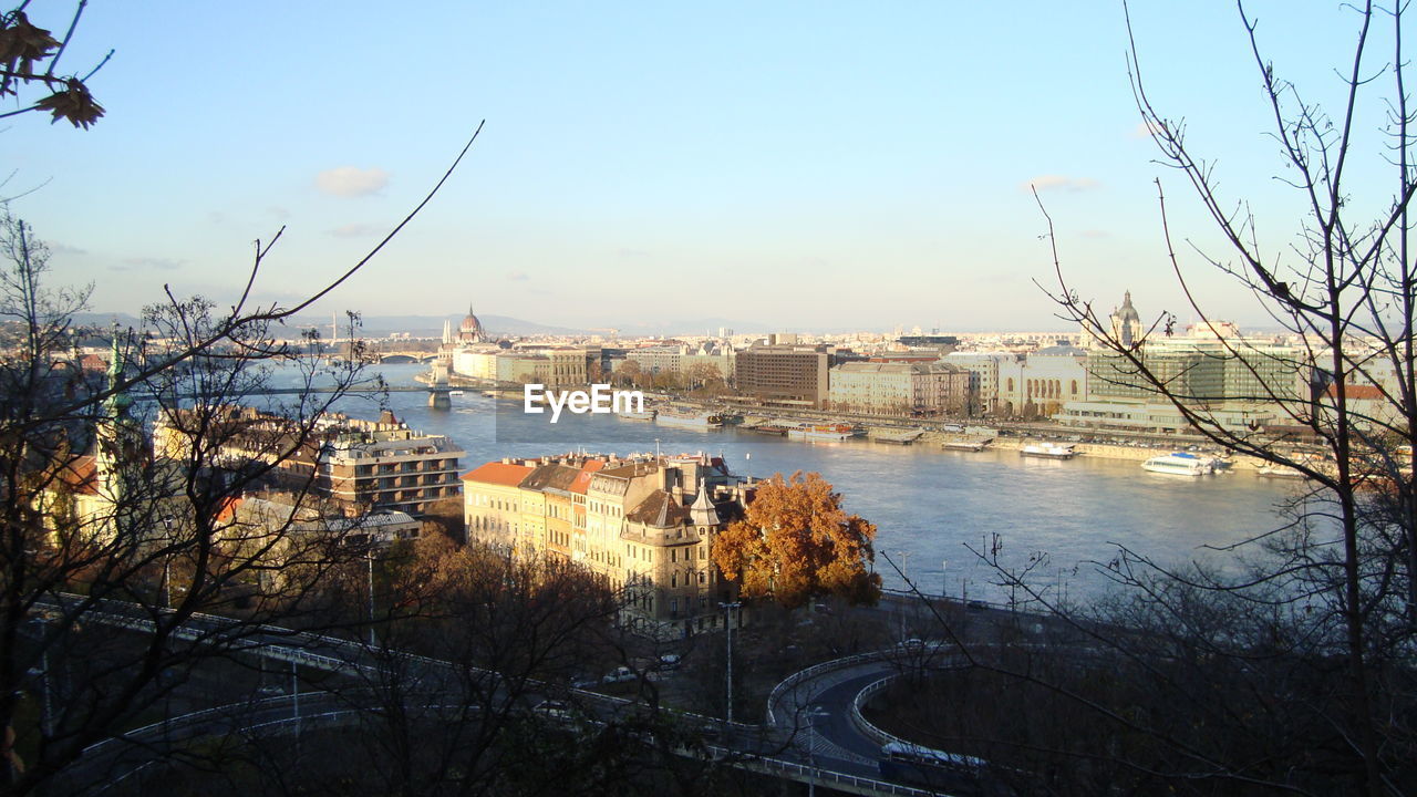 View of city by river against clear sky