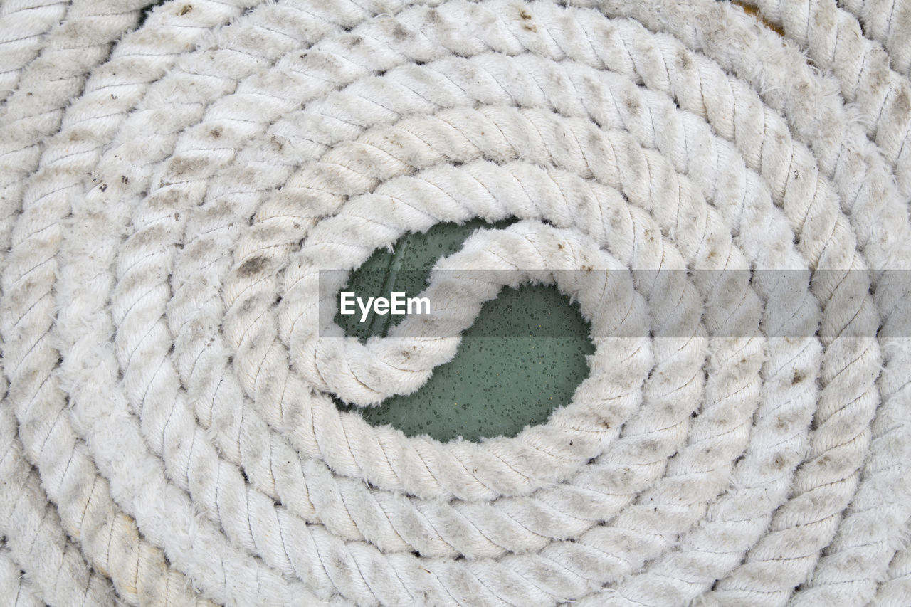 High angle view of spiral shape rope arranged on floor