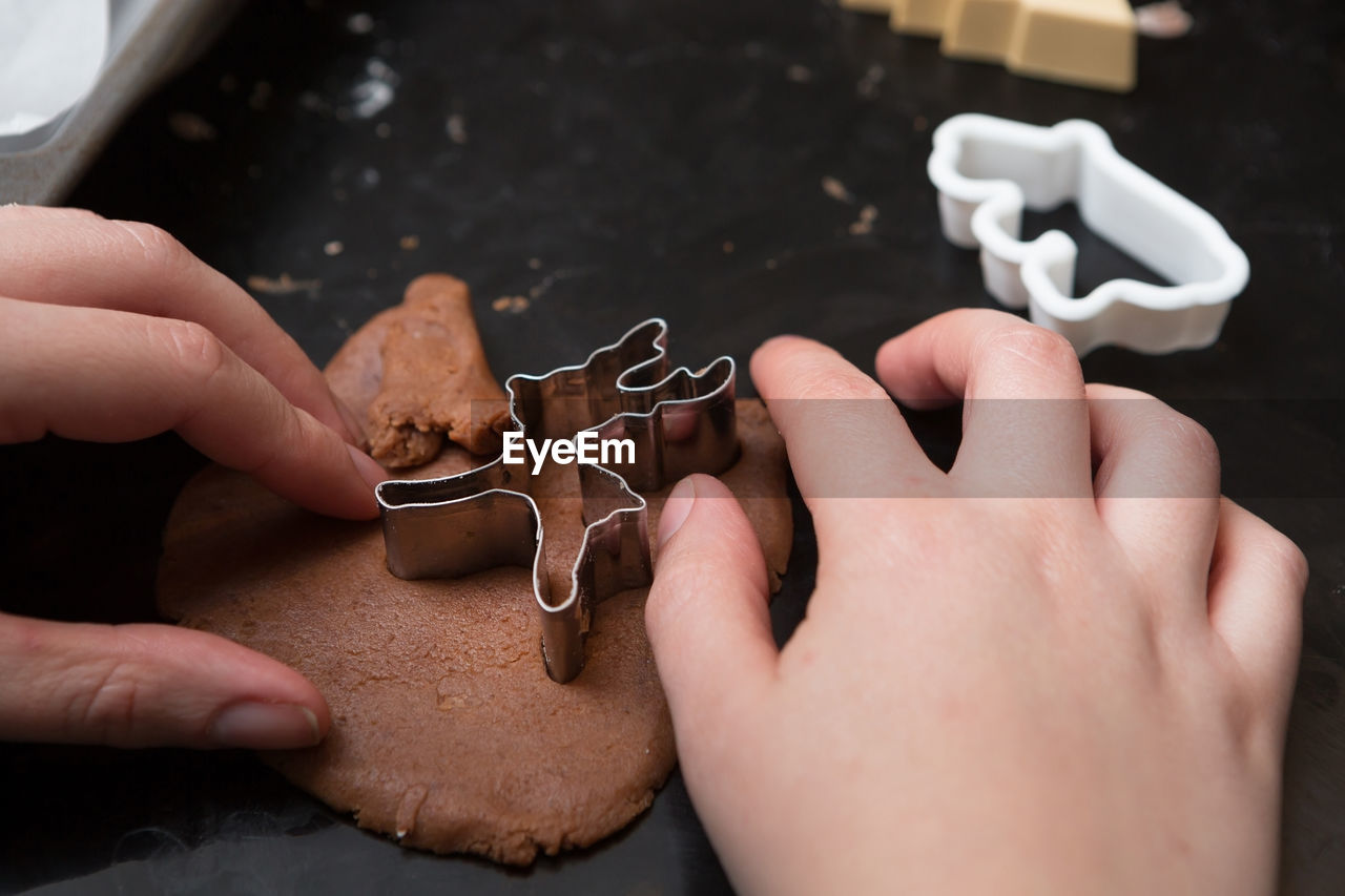 Cropped hands making cookie