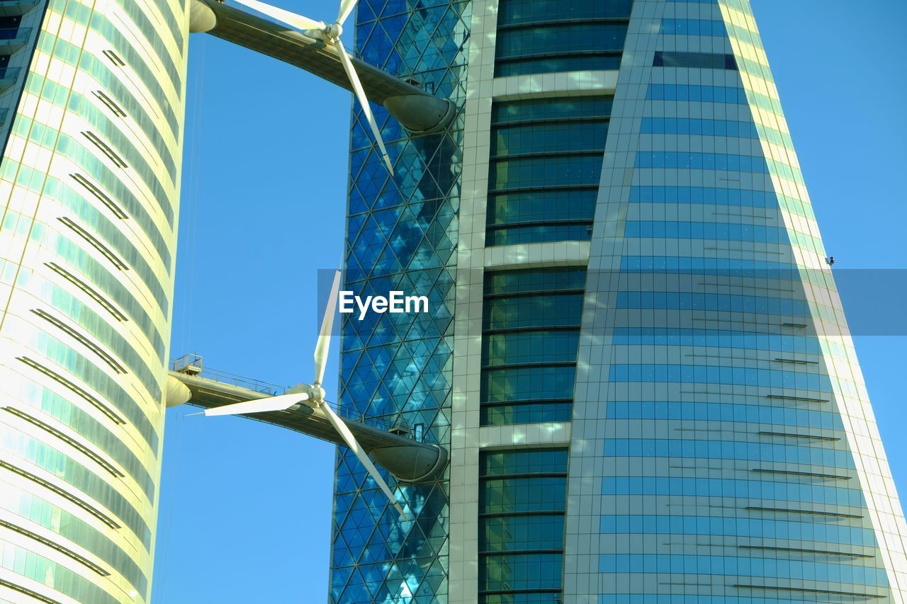 LOW ANGLE VIEW OF MODERN TOWER AGAINST BLUE SKY