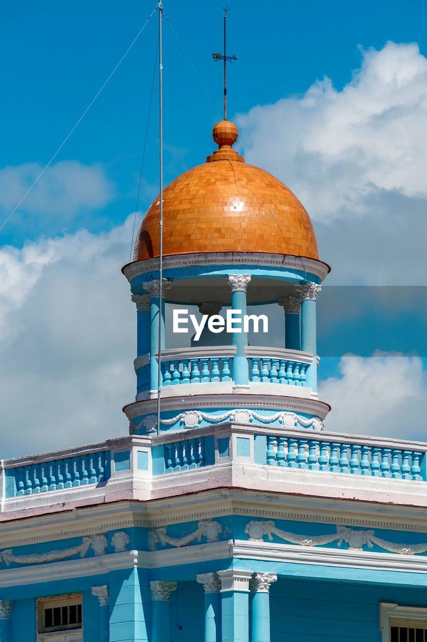 Low angle view of building against cloudy sky