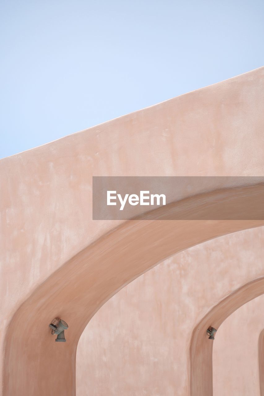 Low angle view of wall against clear sky