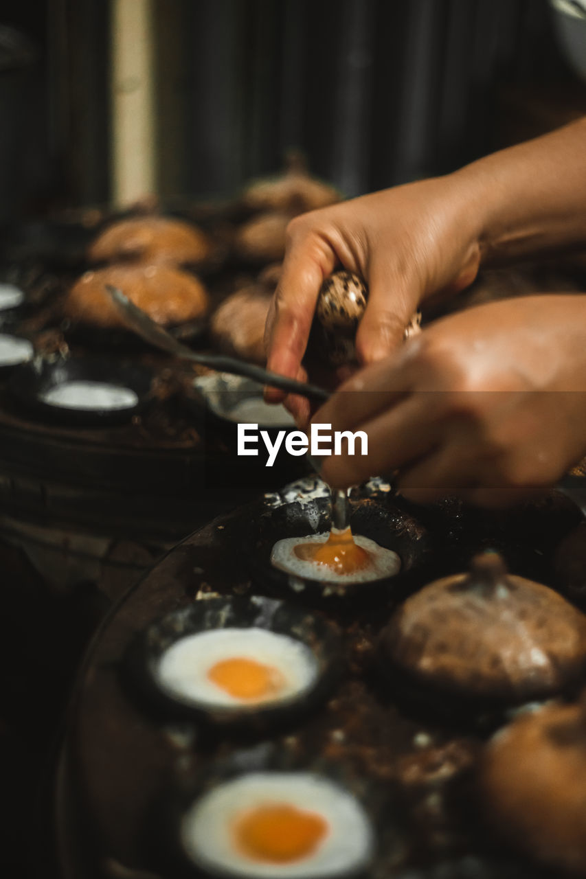 Cropped hands of woman preparing food in kitchen