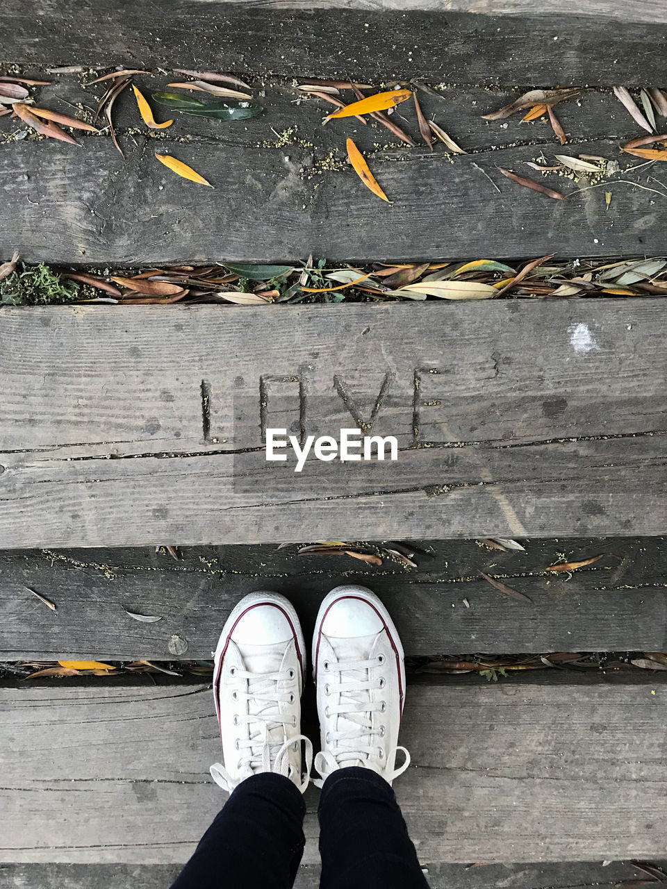 Look from above, love engraved in wood floor