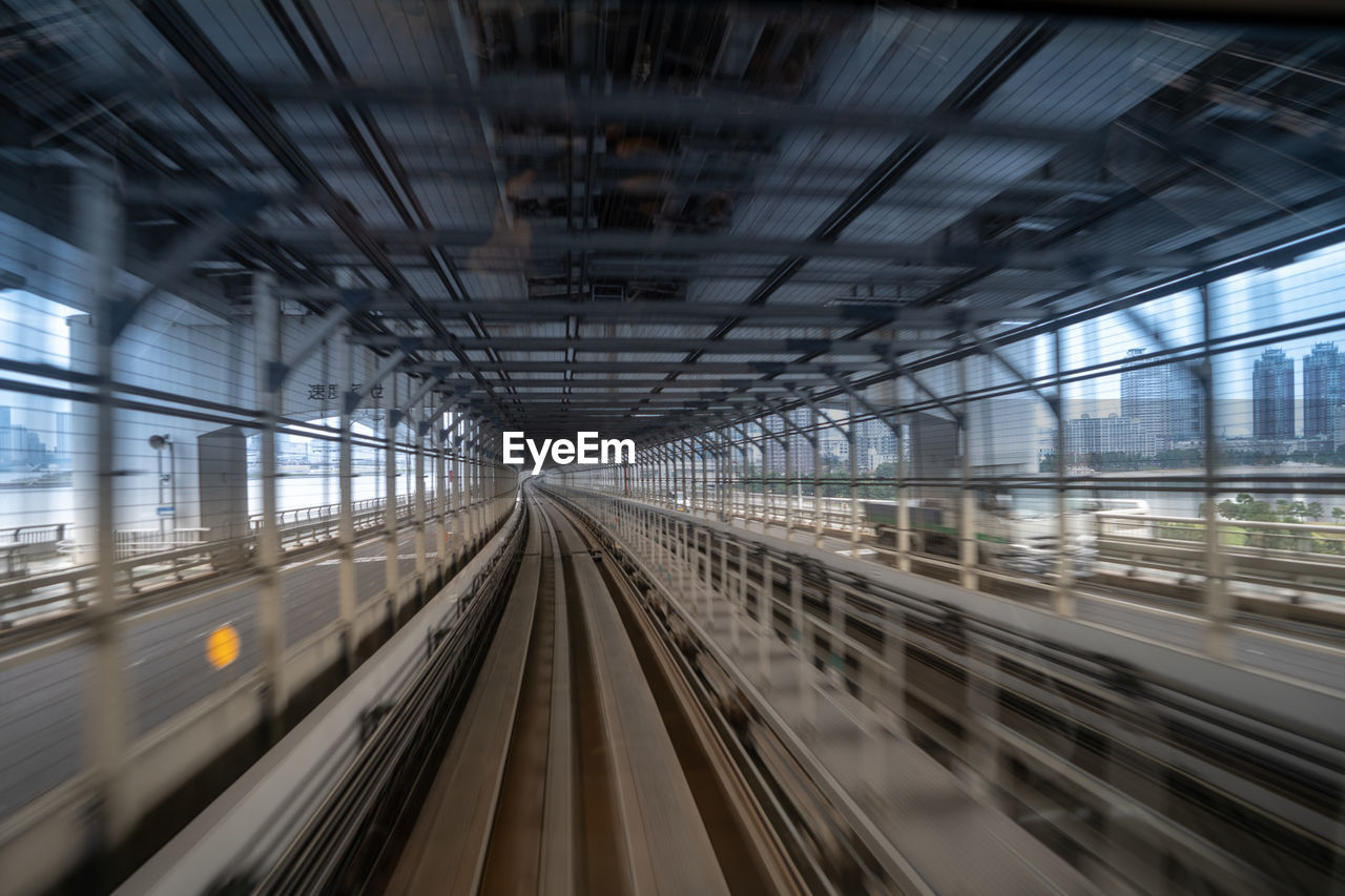 BLURRED MOTION OF TRAIN AT RAILROAD TRACKS