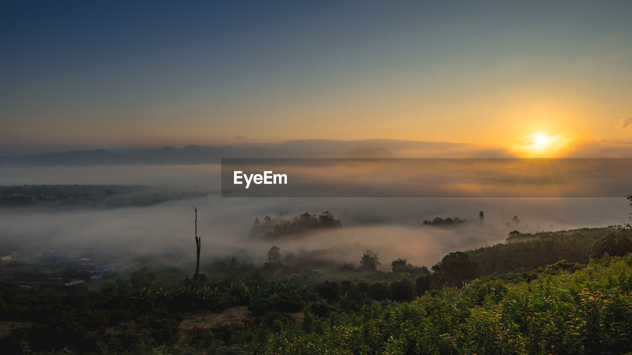 Scenic view of landscape against sky during sunset