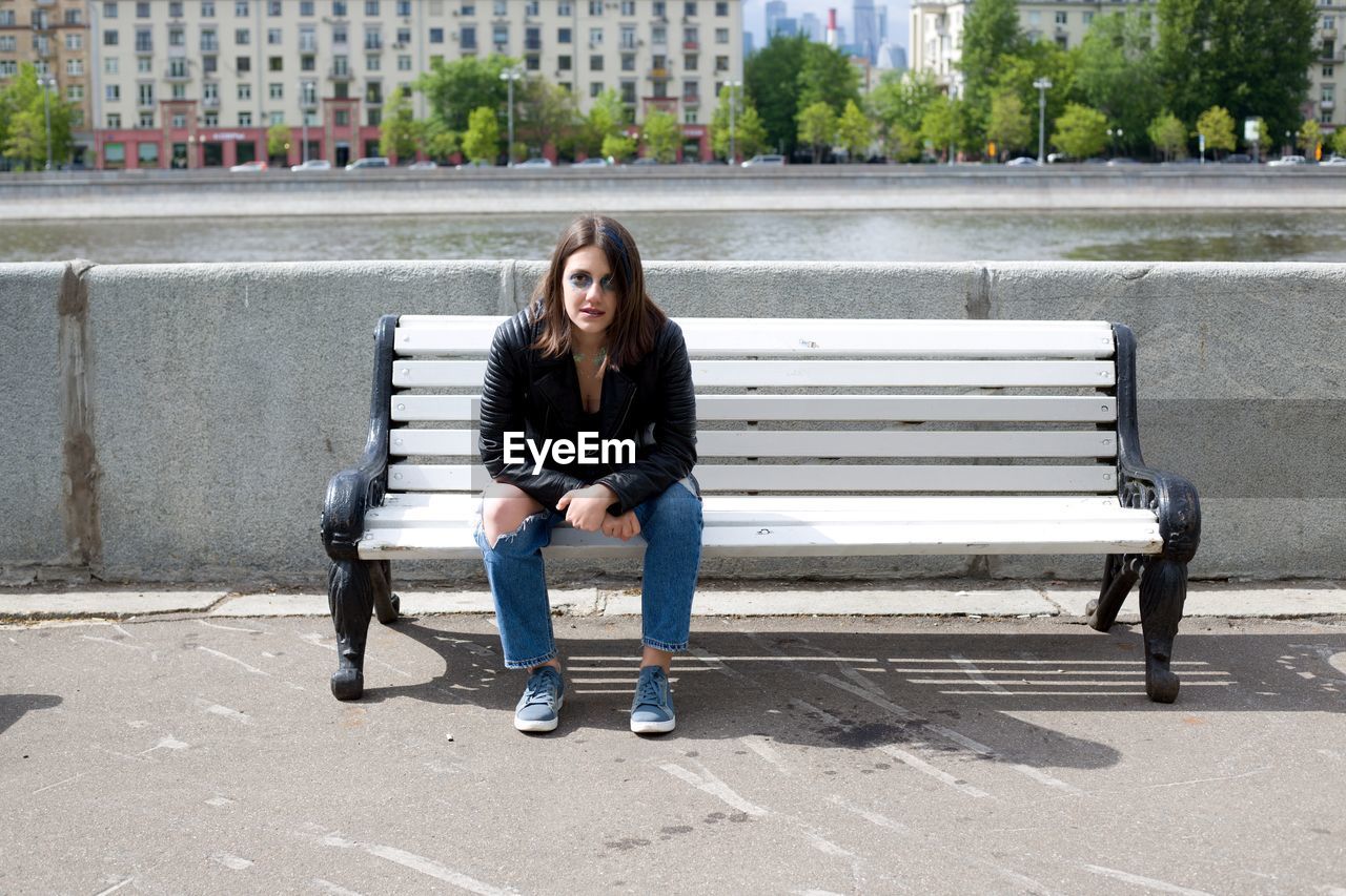 Young woman sitting on bench