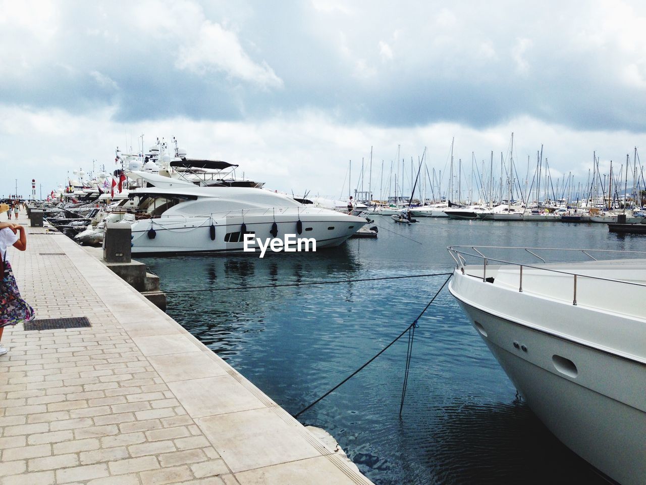 SAILBOATS MOORED IN HARBOR